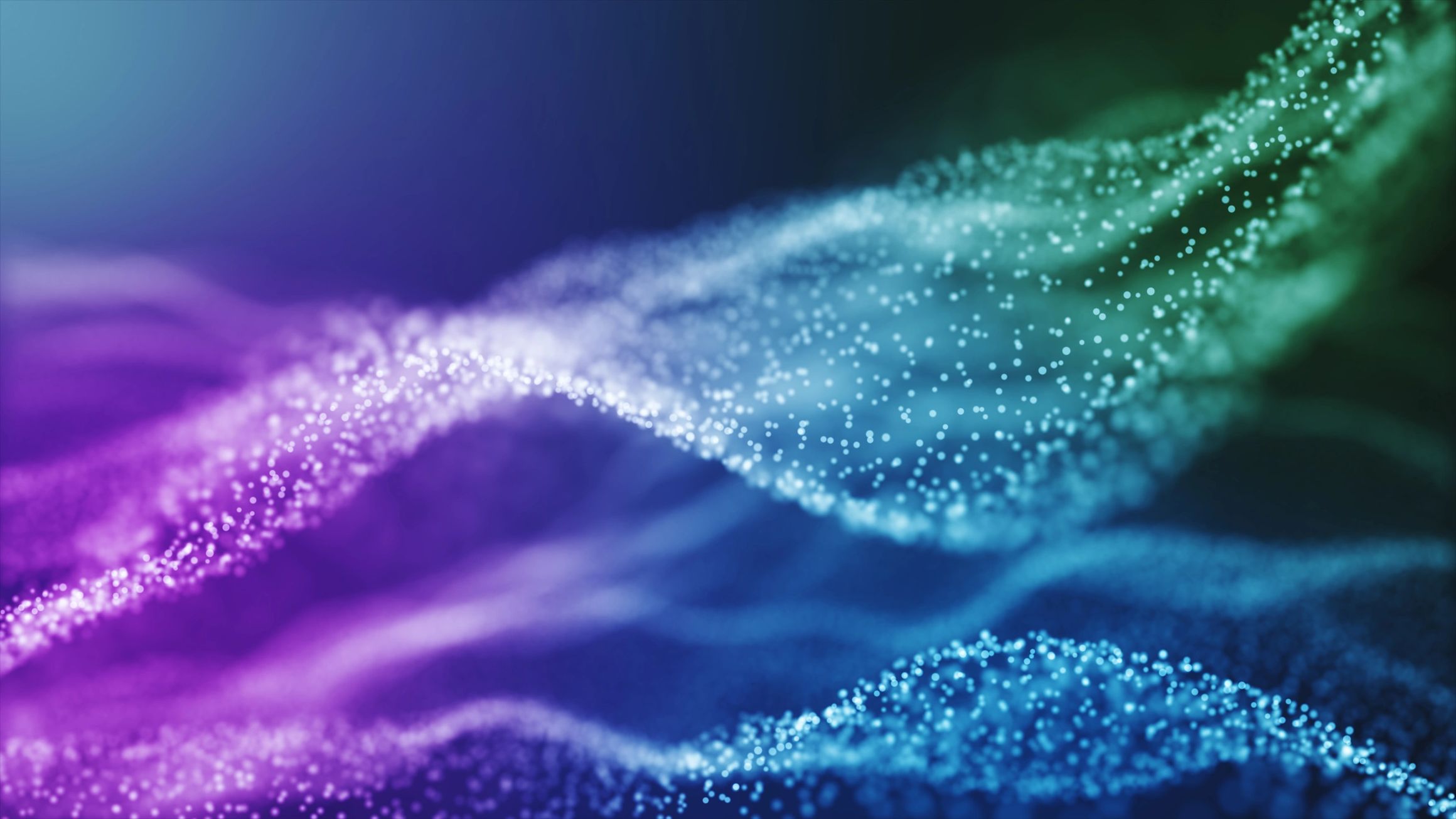 Onda de partículas digitales en tonos morado, azul y verde